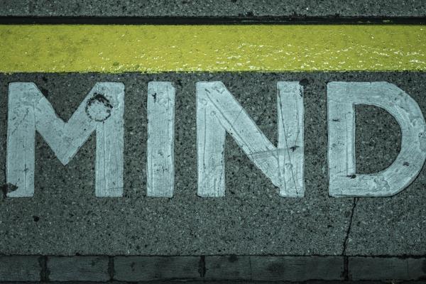 concrete with a yellow stripe and "MIND" in white block lettering