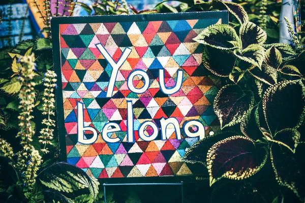 multicolored sign that says "you belong here"