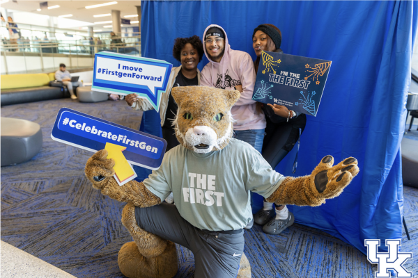 students post with bowman the wildcat holding first gen signs