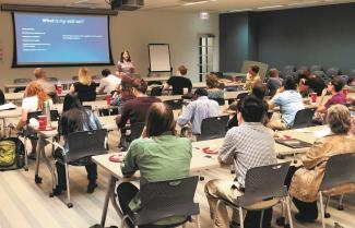 full classroom with presenter at front