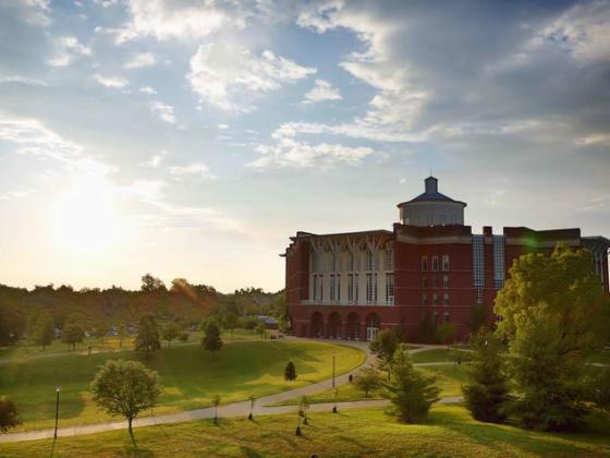 wt young library building with verdant lawn and lens flare from setting sun